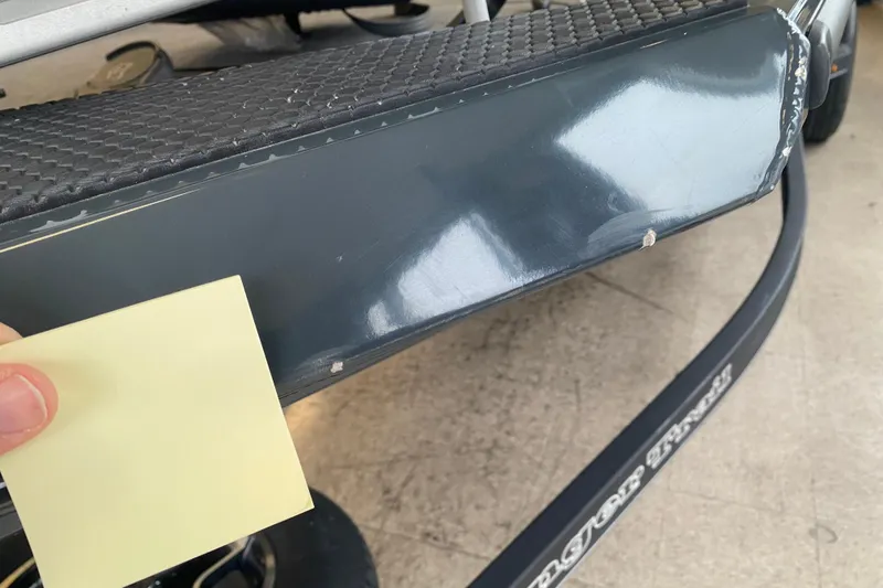 Slide: The Image of 2023 Ranger RT188 boat with minor surface scratches and a hand holding a sticky note. - 12