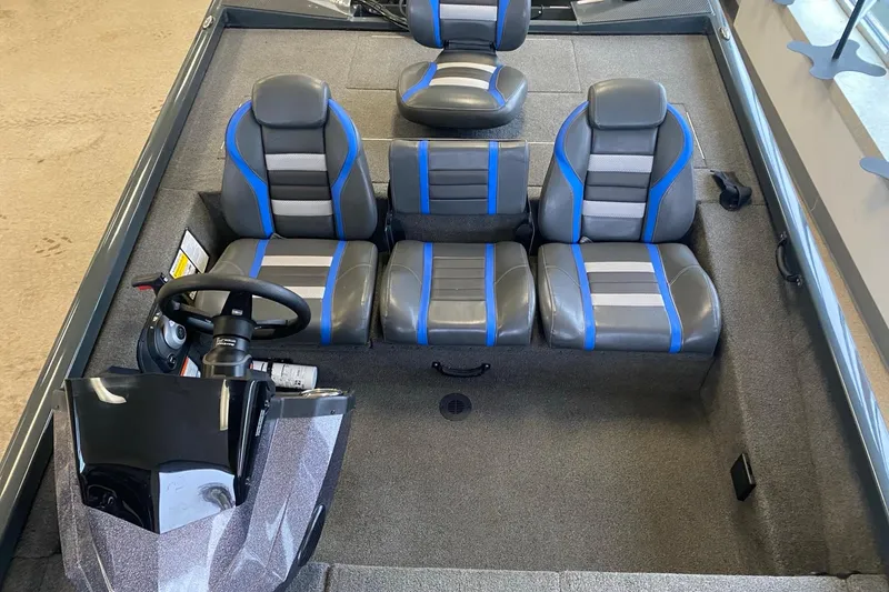 Slide: The Image of 2023 Ranger RT188 boat interior with gray and blue seating, steering console visible. - 7
