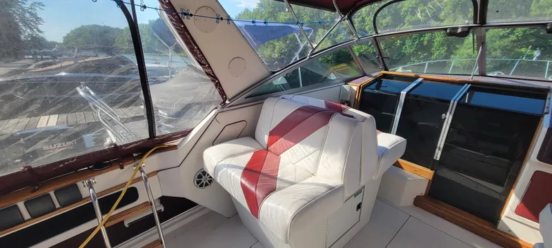 Slide: The Image of Interior of a 1988 Sea Ray 340 Express Cruiser with red seat. - 15