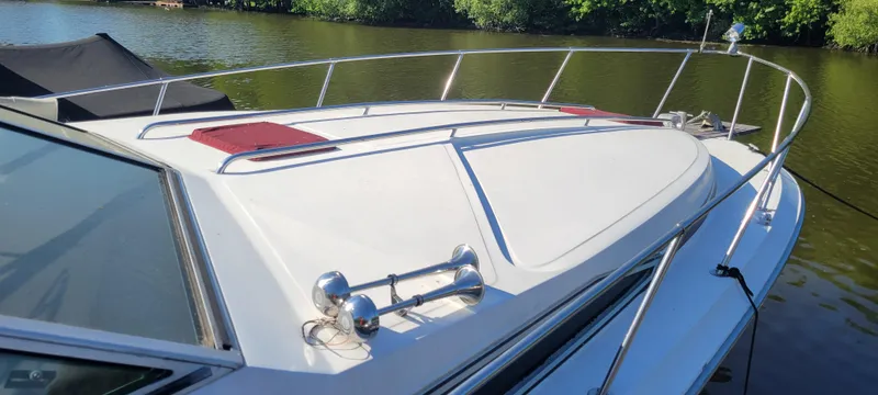 Slide: The Image of 1988 Sea Ray 340 Express Cruiser on calm water. - 2