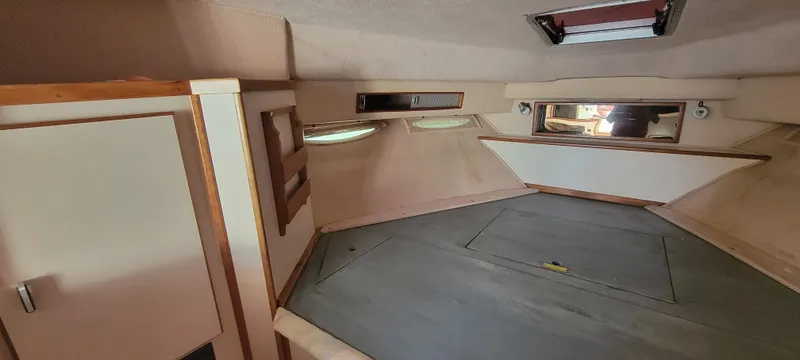 Slide: The Image of Interior of a 1988 Sea Ray 340 Express Cruiser with sleeping area. - 25