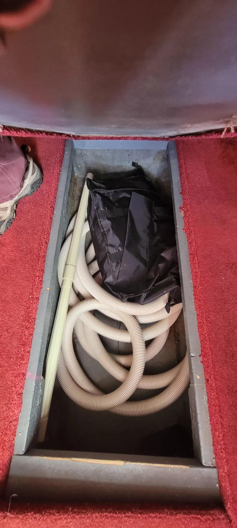 Slide: The Image of Storage compartment in 1988 Sea Ray 340 Express Cruiser with hoses. - 33