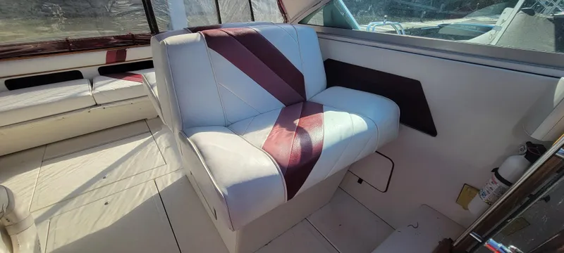 Slide: The Image of Interior of a 1988 Sea Ray 340 Express Cruiser with striped seating. - 37
