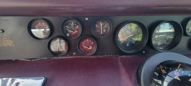 Slide: The Image of Dashboard of a 1988 Sea Ray 340 Express Cruiser with various gauges. - 45