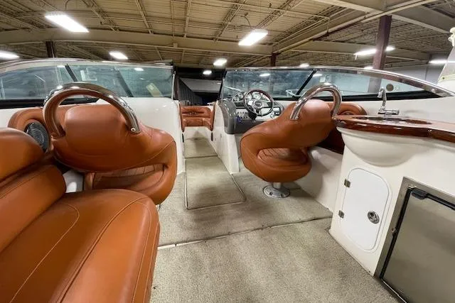 Slide: The Image of 2006 Doral 265 Elite Bowrider interior with brown leather seats and modern dashboard. - 12