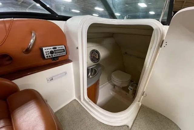 Slide: The Image of 2006 Doral 265 Elite Bowrider interior with compact bathroom and sink. - 13