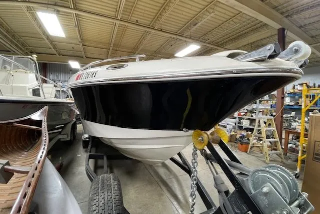 Slide: The Image of 2006 Doral 265 Elite Bowrider boat on trailer in indoor storage facility. - 2