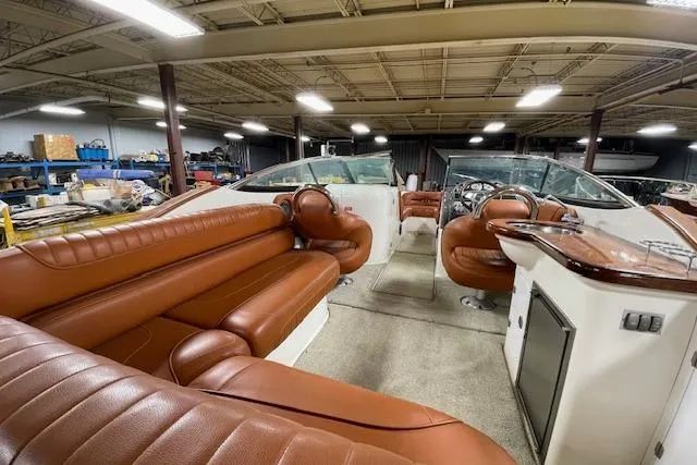 Slide: The Image of 2006 Doral 265 Elite Bowrider with luxurious brown leather seating in a spacious interior. - 3