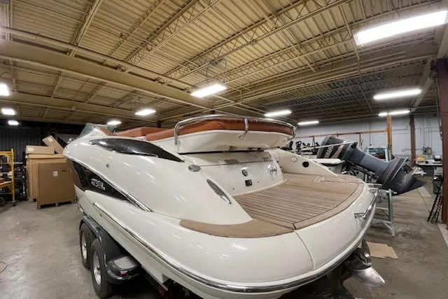 Slide: The Image of 2006 Doral 265 Elite Bowrider in warehouse, showcasing sleek design and spacious deck. - 4