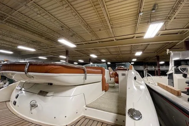 Slide: The Image of 2006 Doral 265 Elite Bowrider in indoor storage, showcasing sleek design and spacious seating. - 6