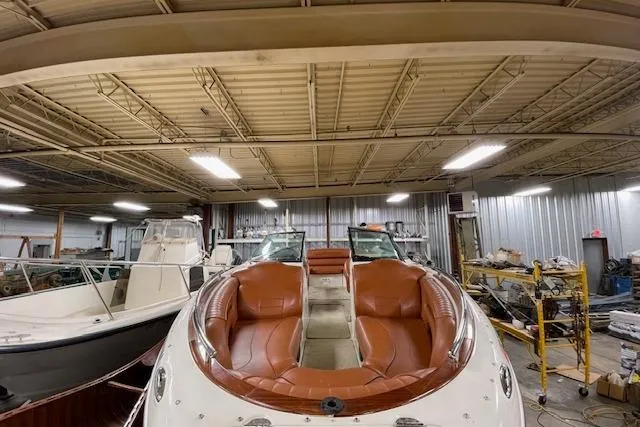 Slide: The Image of 2006 Doral 265 Elite Bowrider with brown leather seats in a storage facility. - 7