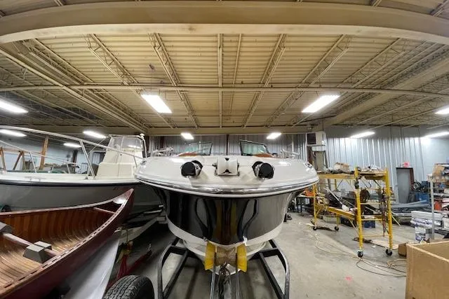 Slide: The Image of 2006 Doral 265 Elite Bowrider in a workshop, surrounded by other boats. - 9