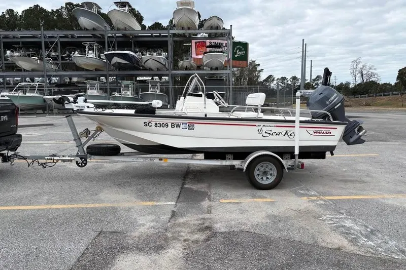 The Image of 2007 Boston Whaler 150 Montauk boat on trailer, parked in marina lot. - 1