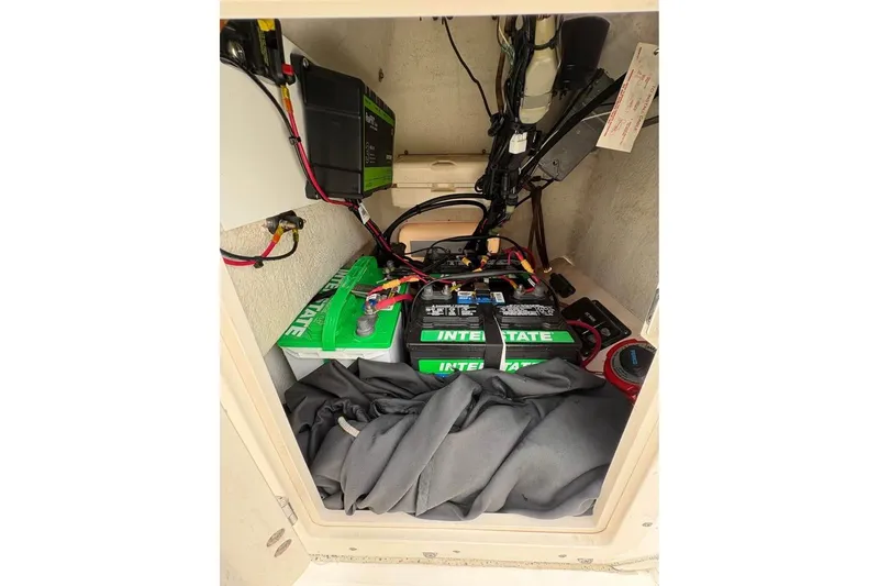 Slide: The Image of 2007 Boston Whaler 150 Montauk battery compartment with Interstate batteries and wiring. - 15