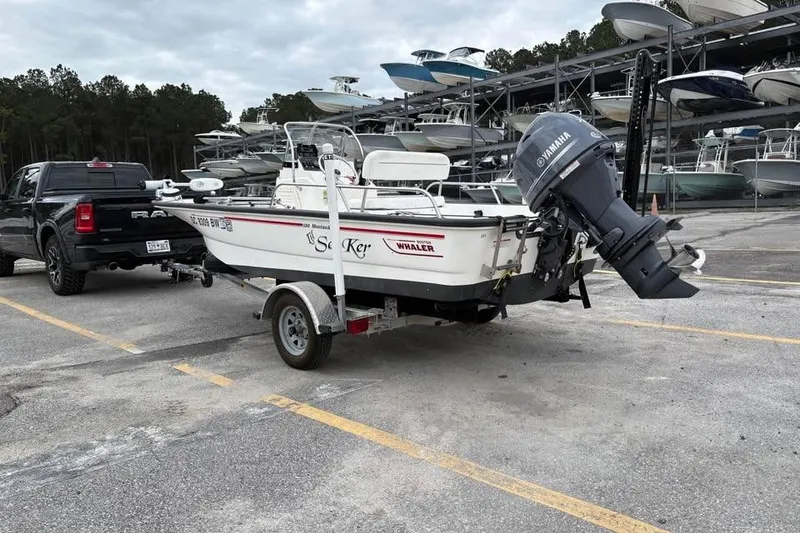 Slide: The Image of 2007 Boston Whaler 150 Montauk boat on trailer, parked in marina lot. - 3