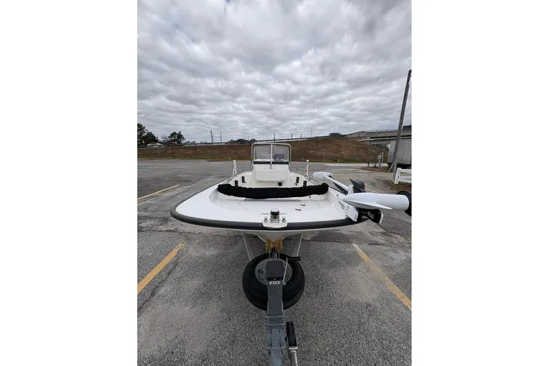 Slide: The Image of 2007 Boston Whaler 150 Montauk boat on trailer under cloudy sky. - 8