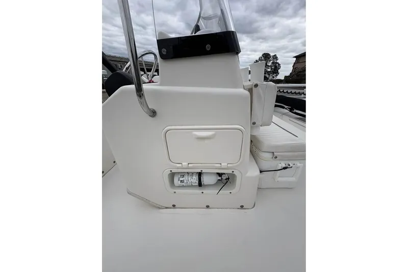 Slide: The Image of 2007 Boston Whaler 150 Montauk boat console with storage compartment and seating. - 9