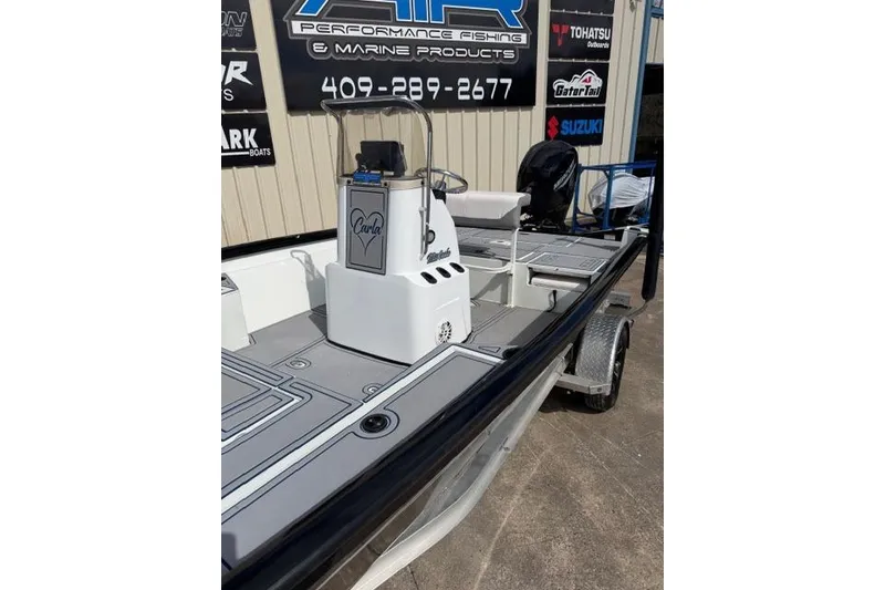 Slide: The Image of 2022 Crestliner 2000 Bay boat on trailer, displayed at a marine products store. - 3