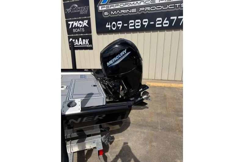 Slide: The Image of 2022 Crestliner 2000 Bay boat with Mercury outboard motor displayed outdoors. - 6