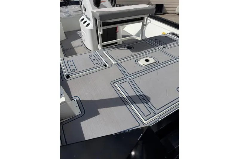 Slide: The Image of 2022 Crestliner 2000 Bay boat deck with seating and storage compartments. - 8