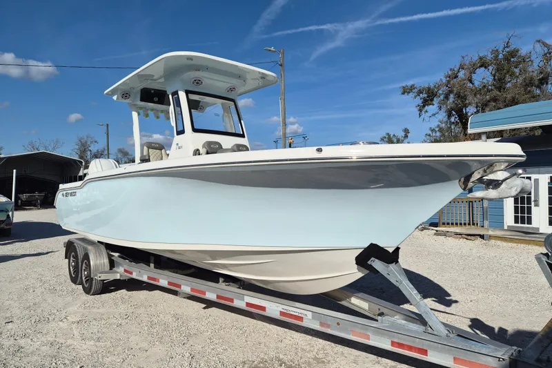The Image of 2026 Key West 263 FS boat on trailer under clear blue sky. - 1