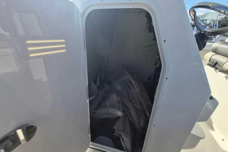 Slide: The Image of Open storage compartment on 2026 Key West 263 FS boat, showing interior details. - 12
