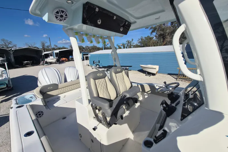 Slide: The Image of 2026 Key West 263 FS boat interior with dual seats and steering console. - 4