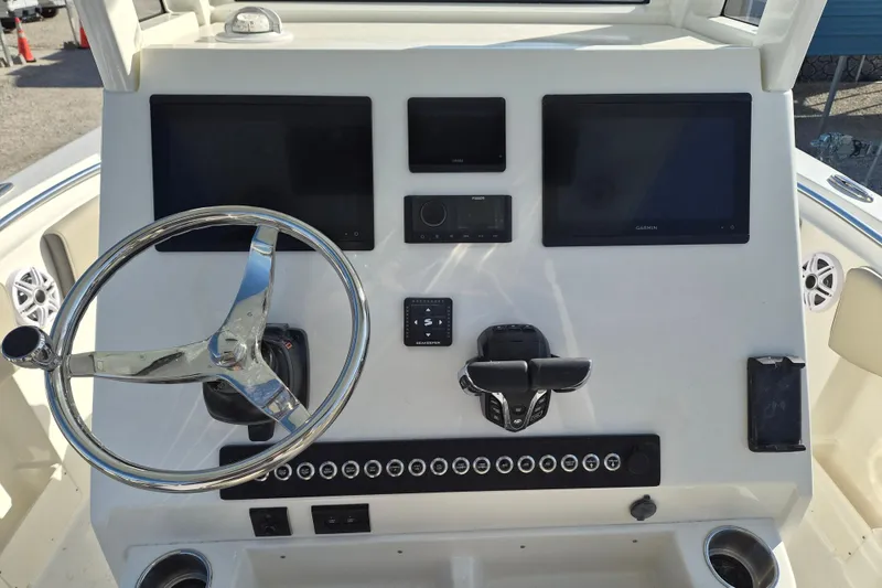 Slide: The Image of 2026 Key West 263 FS boat dashboard with steering wheel and electronic displays. - 7