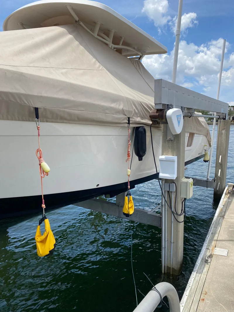 Slide: The Image of Century 3200 boat 2020 at dock with cover. - 3