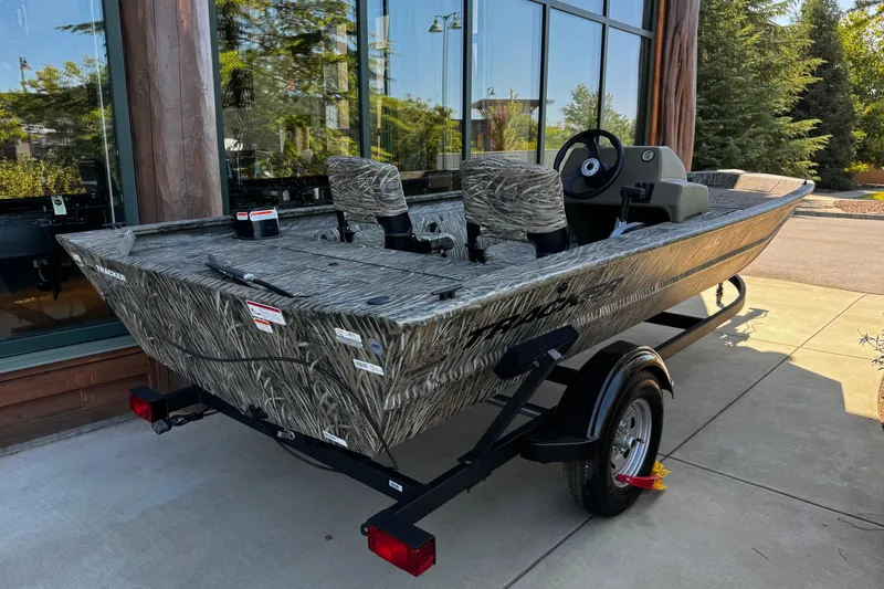 Slide: The Image of 2026 Tracker Grizzly 1754 SC boat with camouflage design on a trailer. - 3