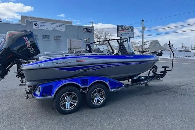The Image of 2026 Ranger 1880MS boat with trailer, blue and gray design, parked outdoors. - 0