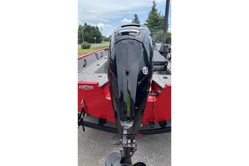 The Image of 2026 Tracker Pro Guide V-16 SC boat with powerful outboard motor, red and gray design. - 0