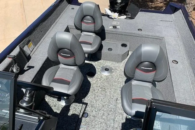 Slide: The Image of 2026 Tracker Pro Guide V-175 WT boat interior with four gray seats and carpeted flooring. - 14