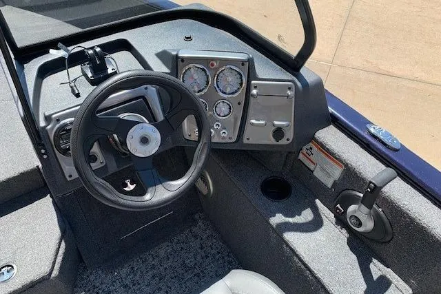 Slide: The Image of 2026 Tracker Pro Guide V-175 WT boat dashboard with steering wheel and instrument panel. - 15