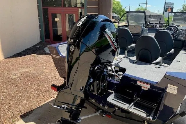 Slide: The Image of 2026 Tracker Pro Guide V-175 WT boat with Mercury outboard motor, parked outdoors. - 17