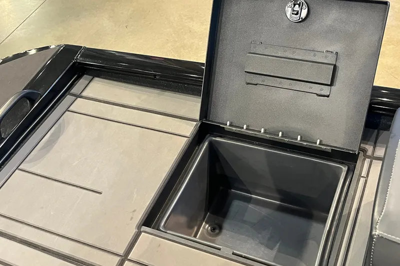 Slide: The Image of Open storage compartment on 2026 Tracker Savage 215 boat deck. - 14