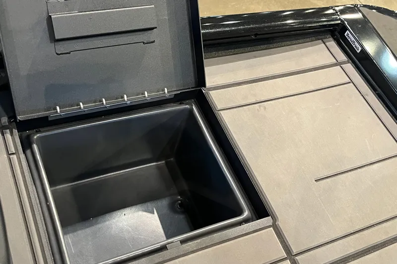 Slide: The Image of Open storage compartment on 2026 Tracker Savage 215 boat deck. - 15