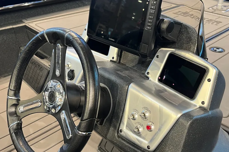 Slide: The Image of Steering console of 2026 Tracker Savage 215 boat with modern controls and display. - 20