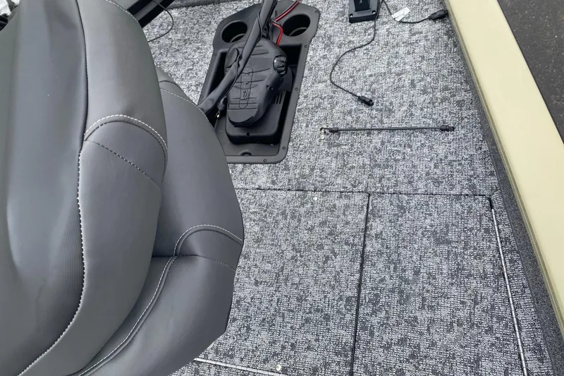 Slide: The Image of Interior of 2026 Tracker Pro Team 175 boat with gray seating and carpeted flooring. - 2