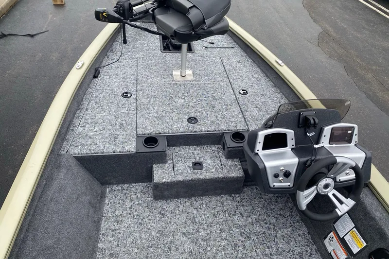 Slide: The Image of 2026 Tracker Pro Team 175 boat interior with steering console and seating. - 5