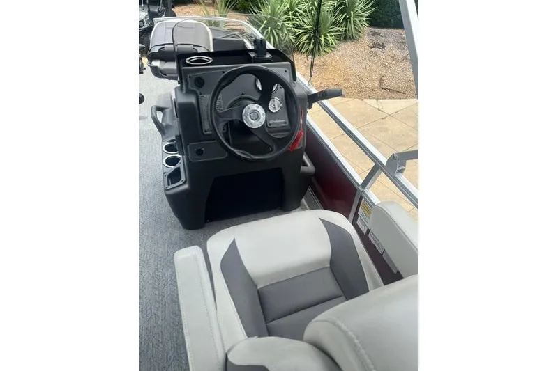 Slide: The Image of 2026 Sun Tracker Bass Buggy 18 DLX boat interior with steering console and seating. - 4