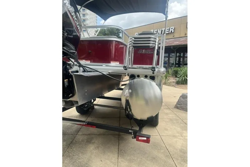 Slide: The Image of 2026 Sun Tracker Bass Buggy 18 DLX pontoon boat on trailer, rear view. - 9