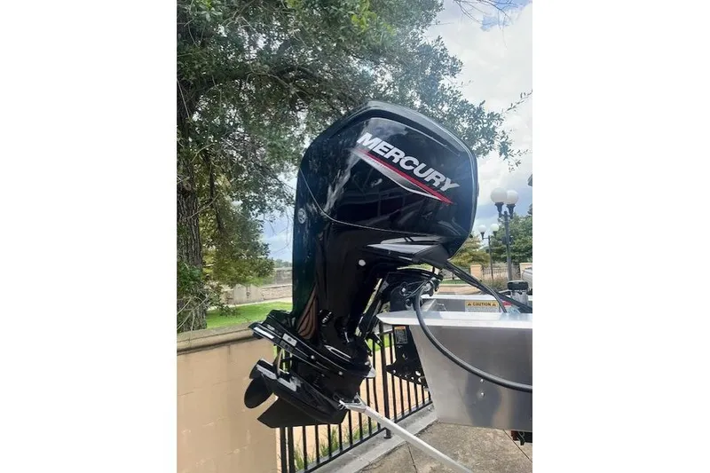 Slide: The Image of Mercury outboard motor on 2026 Sun Tracker Bass Buggy 18 DLX, parked outdoors. - 10