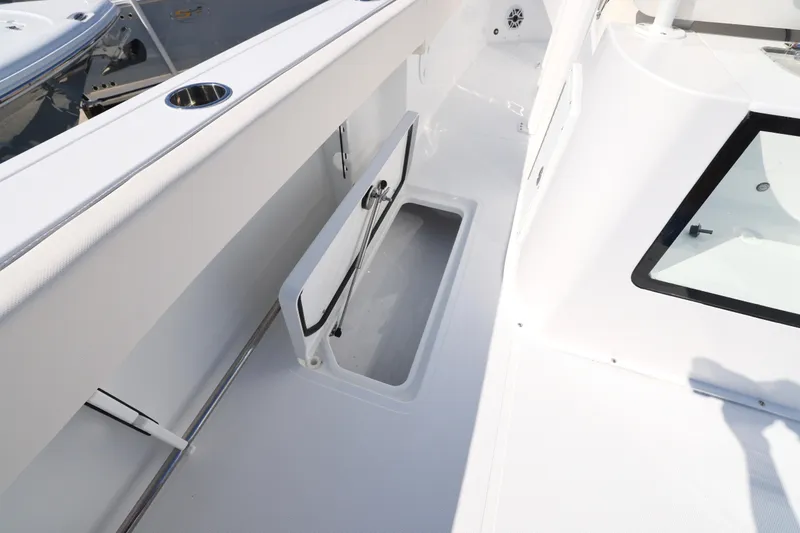 Slide: The Image of 2026 Sea Hunt Gamefish 27 Forward Seating boat interior with storage compartment. - 14