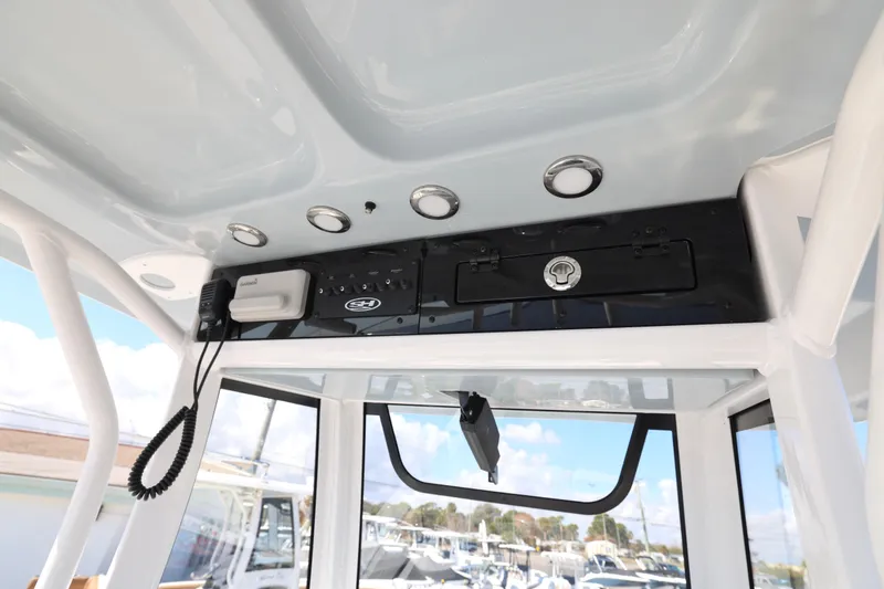 Slide: The Image of 2026 Sea Hunt Gamefish 27 Forward Seating boat console with electronics and storage. - 15