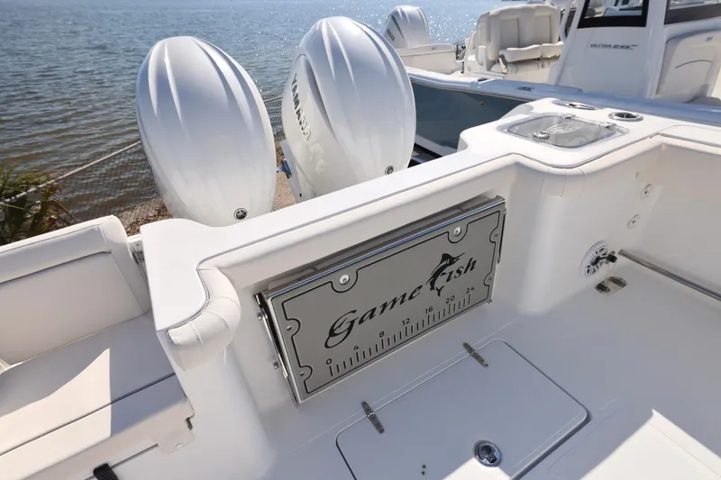 Slide: The Image of 2026 Sea Hunt Gamefish 27 boat with dual Yamaha engines, featuring forward seating. - 19