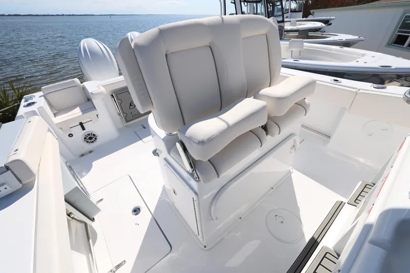 Slide: The Image of 2026 Sea Hunt Gamefish 27 Forward Seating boat interior with plush seating and ocean view. - 20