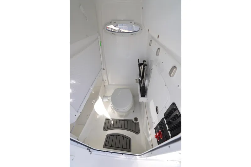 Slide: The Image of Interior of 2026 Sea Hunt Gamefish 27 boat, featuring compact marine toilet. - 21