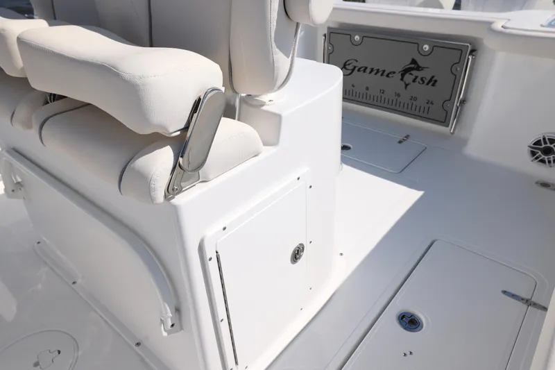 Slide: The Image of 2026 Sea Hunt Gamefish 27 Forward Seating interior with white cushioned seats and storage compartments. - 22