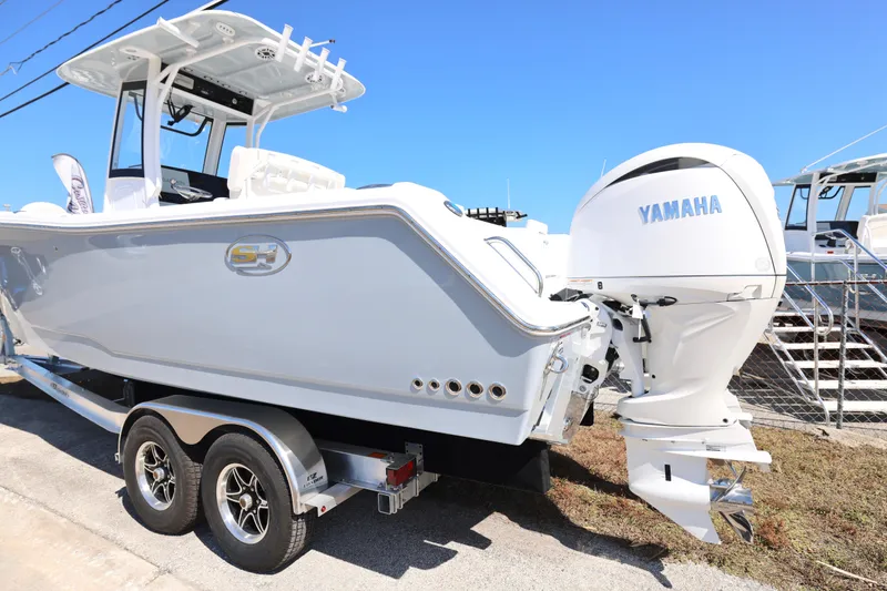 Slide: The Image of 2026 Sea Hunt Gamefish 27 boat with Yamaha engine on trailer, side view. - 30